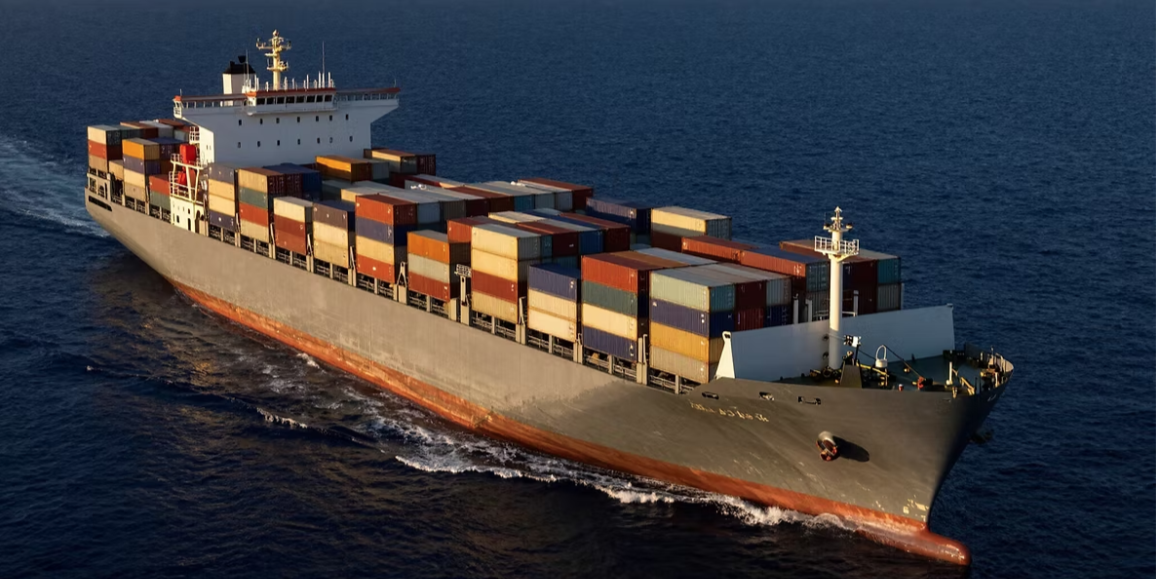 Container ship carrying stacked cargo containers across the ocean