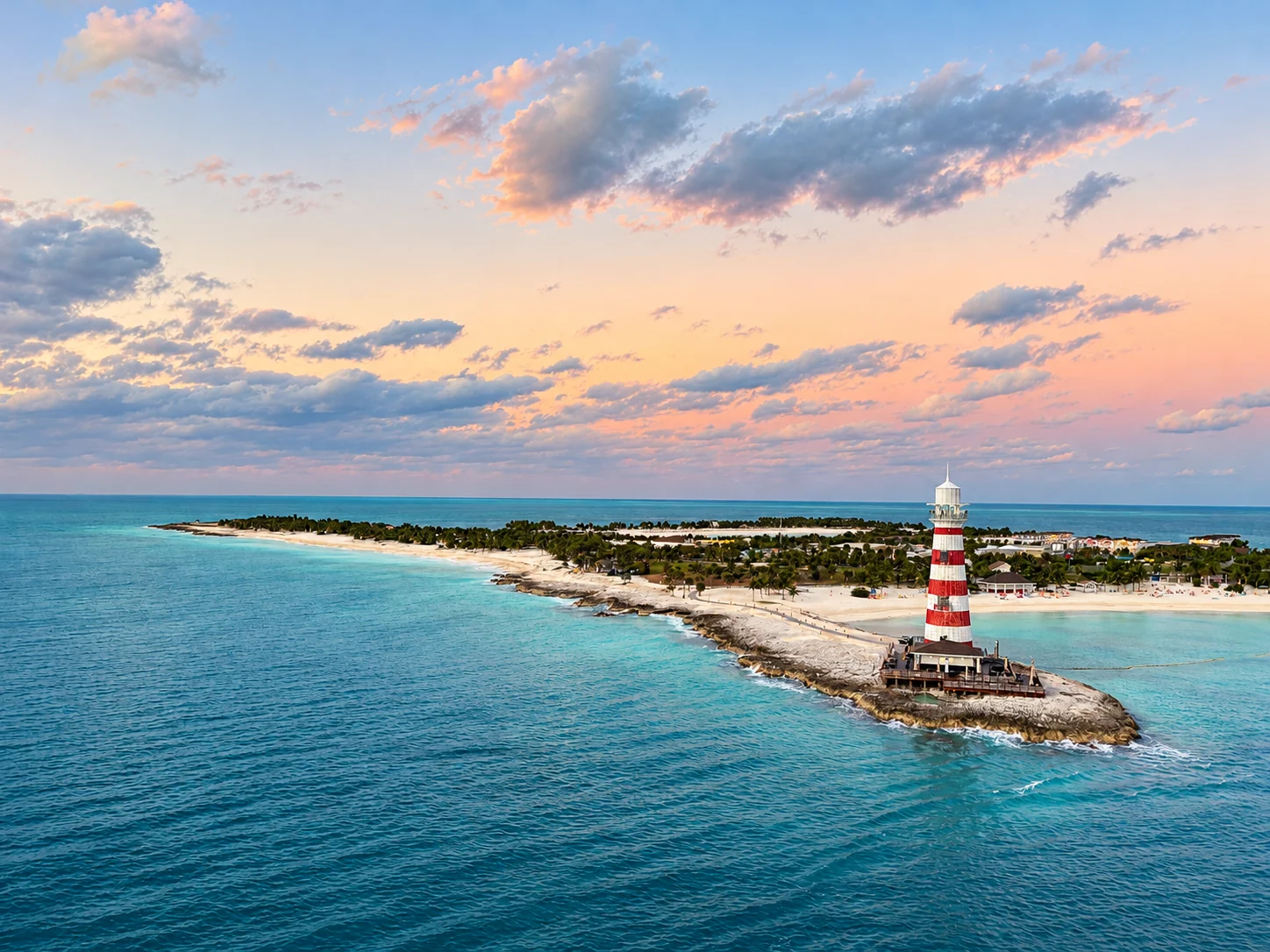 Beach and red-and-white lighthouse on an island